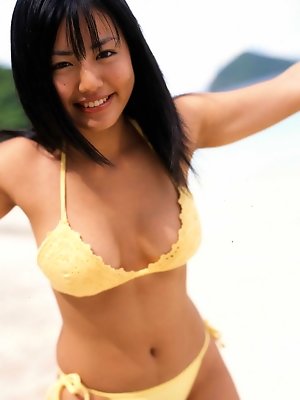 A tight skimpy red bikini holds in this idols big busty boobs